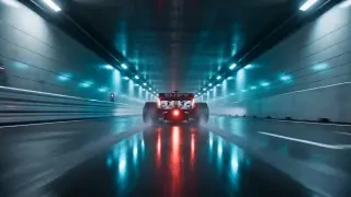 Fotograma del video final — el monoplaza se lanza hacia el túnel iluminado en cian